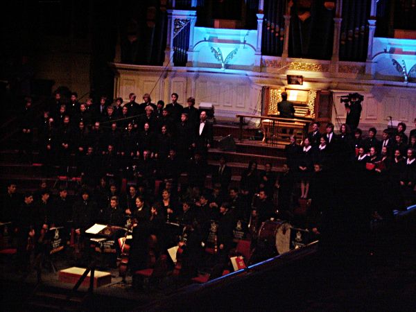 A performance on risers, with illuminated organ in background