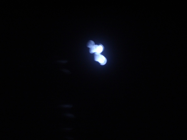 An overexposed moon, blurry, blue filter