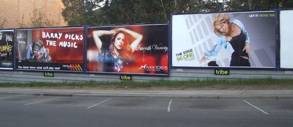 Three billboards for competing radio networks in a row