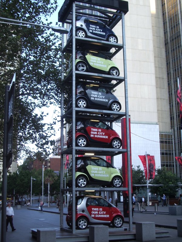 Smart cars stacked on top of one another in some form of 'art'