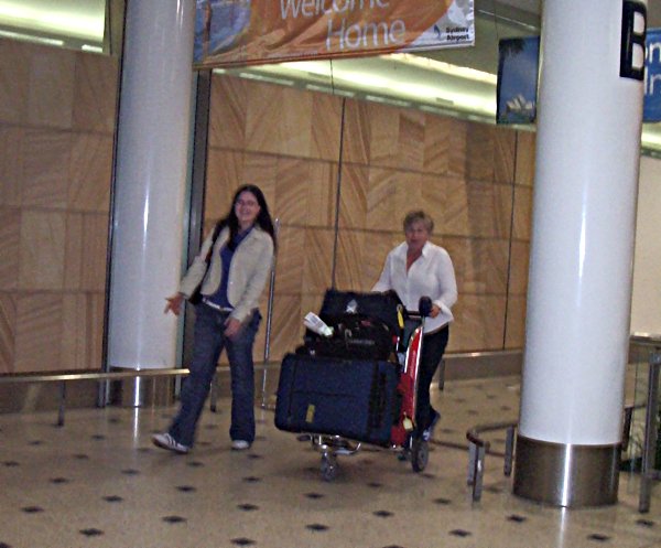Tori and her mum walking into the Arrivals area at Sydney International Airport