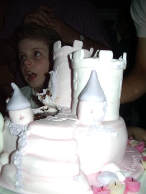 Cake foreground, surprised-looking kid background